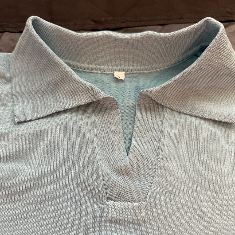 Light blue short sleeve women’s sweater. Brand new. Size Large.